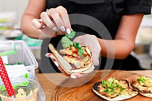 Street vendor hands making taco outdoors