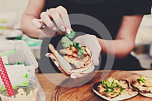 Street vendor hands making taco outdoors