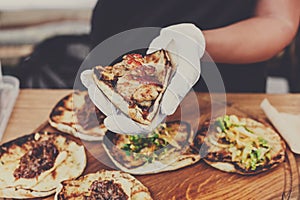 Street vendor hands making taco outdoors