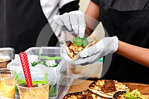 Street vendor hands making taco outdoors