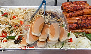Street vendor with hot dogs and grilled onions