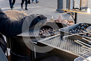 A street vendor roast chestnuts in Lisbon, Portugal