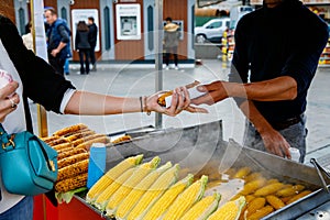 A street vendor roasts corn on a charcoal grill in Istanbul, Turkey. Misir, a popular Turkish street food, is freshly
