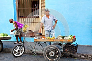 Street vendor selling fruit and vegetables on his bike in the streets of Camaguey, Cuba