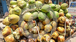 Street Vendor selling ripe palmyra palm and green coconut on a van at street of Dhaka, Bangladesh