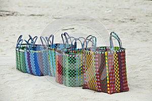 Street vendor selling straw hats and handbags