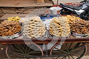 A street vendor selling sweets outside the Jagatpita Brahma Mandir Rama temple in Pushkar, India