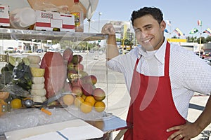 Street Vendor Standing By Stall photo