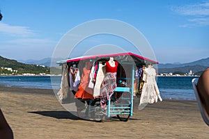 Street vendors carry their shop on the sand of Manzanillo Colima beach.