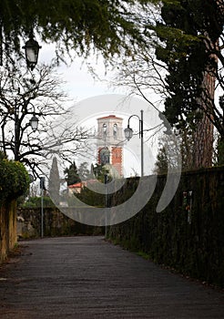 Street in Vicenza in Northern Italy where two friars were brutally murdered and bell tower of the Basilica of Monte Berico