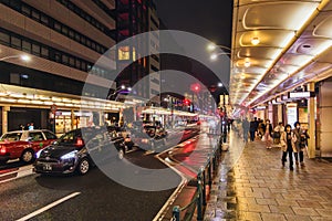 Street view with busy traffic, downtown of Kyoto, Japan, at night