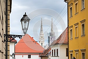 Street view of the cathedral towers over the rooftops in Zagreb, Croatia