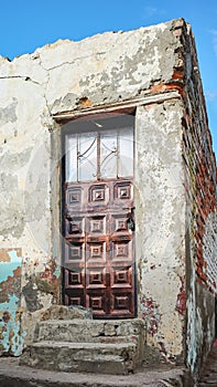 Street view of an old building facade with metal door, Latacunga, Ecuador photo
