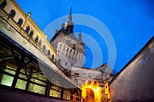 Street view of the old Clock Tower monument building `Turnul cu ceas` in SighiÃâ¢oara, Romania photo