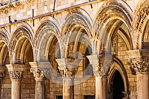 street view of the old town of Dubrovnik in Croatia, arches with columns, architectural details, medieval European architecture,