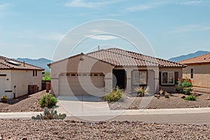 Street view of a suburban home with xeriscape landscaping.
