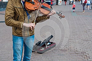 Street violinist plays the violin at noon