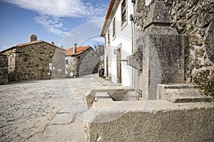 A street and a water fountain in Linhares da Beira Historical Village