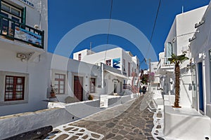 Street with white houses in town of Mykonos, Greece