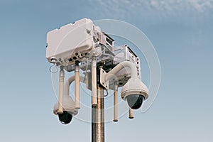Street wi-fi router on a pole with video cameras against the sky