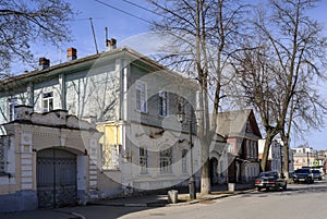 A street with wooden and brick houses and carved platbands of the 19th century in Gorodets, Russia, in spring