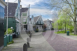 Street in the Zaan region of a village , with traditional wooden green houses . photo