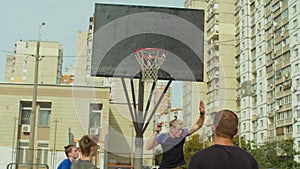 Streetball player scoring points after rebound