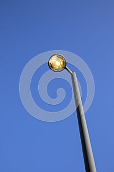 Streetlamp against blue sky