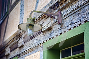 Streetlamp hanging above old door at vintage house