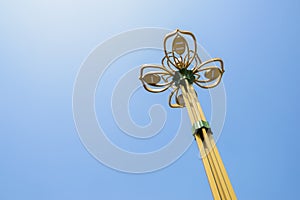 Streetlamp towering in blue sky