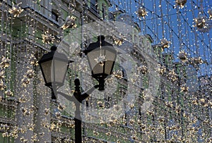 Streetlight and strands of shiny garlands. New Year\'s illumination on the streets of the city