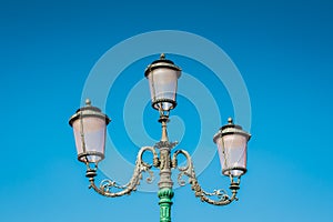 Streetlight vintage style, retro Lamppost on blue sky background