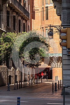 Streets of Barcelona. A view from Via Laietana to a street with buildings, trees and box office.