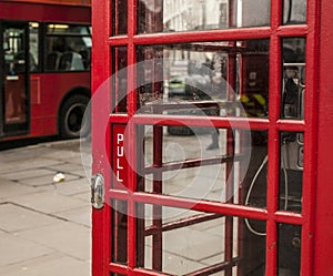 Streets of London - red phone booth and a red bus.