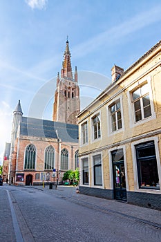 Streets of old Bruges and Church of Our Lady tower, Belgium