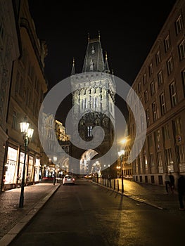 Streets of Prague Czech Republic at night with Mala Strana Bridge Tower in the background