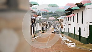 Streets of San Agustin, Huila province in Colombia. Umbrellas on the street.