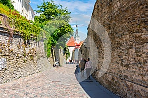 Streets of Tallinn old town with St. Olaf`s church Oleviste kirik tower, Estonia