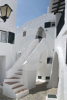 Streets and white walls of touristic fishing village of Binibeca Vell