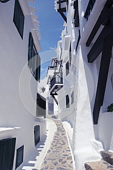 Streets and white walls of touristic fishing village of Binibeca Vell