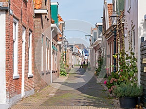 Streetscene of narrow Midstrjitte in Waldsein, Woudsend, Friesland, Netherlands