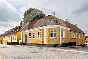 Streetscene of Sondergade with yellow houses in Hobro, Nordjylland, Denmark