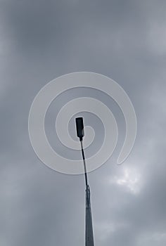 Streetside lamppost with cloudy sky. photo