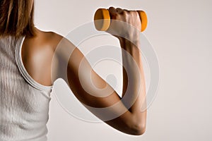 Strength in Hand: Fitness Model with Yellow Dumbbell