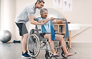 Strength lies in balance. Full length shot of a senior man in a wheelchair exercising with a resistance band along side