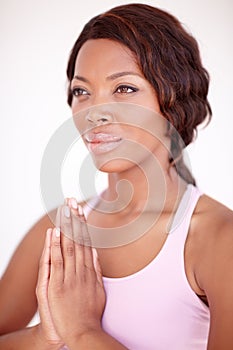 Strength of mind - Yoga. A beautiful young african-american woman relaxing with a yoga routine.