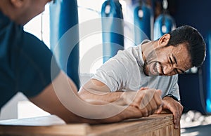 Strength, motivation and men arm wrestling in a gym on a table while being playful for challenge. Rivalry, game and male