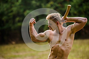 Strength and power concept. Handsome shirtless man muscular body. Forester with axe. Sexy macho bare torso. Surviving in