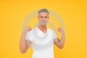 Strength and power. Happy bachelor show strength. Strong man flex arms yellow background. Strength and confident