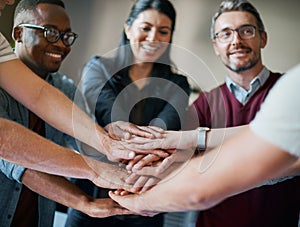 Strength and success lies in unity. a group of businesspeople joining their hands together in unity.